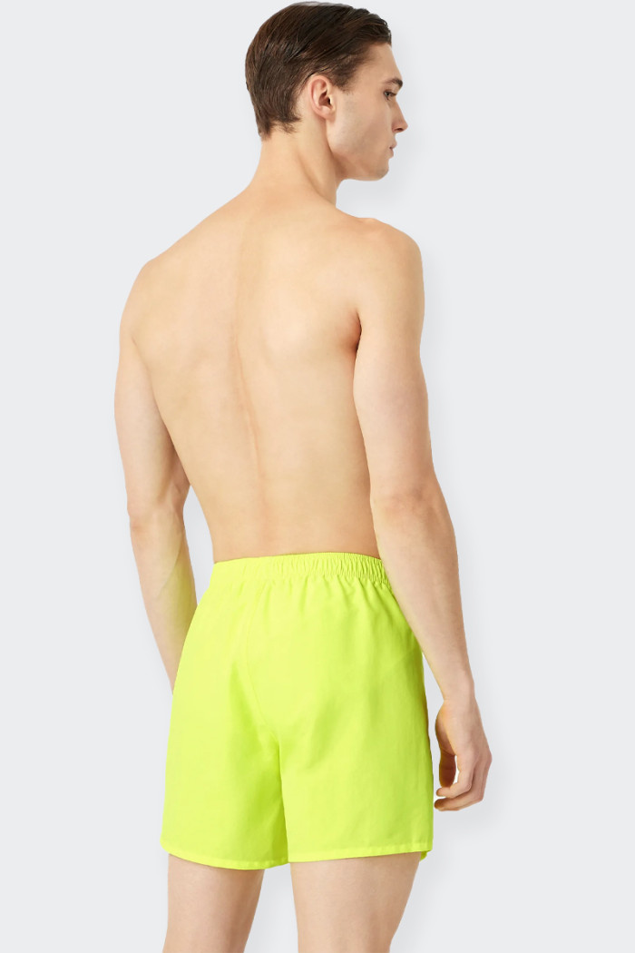 Men's swimming costume, boxer model, perfect for the pool and the beach. The garment has a convenient back pocket and is embelli