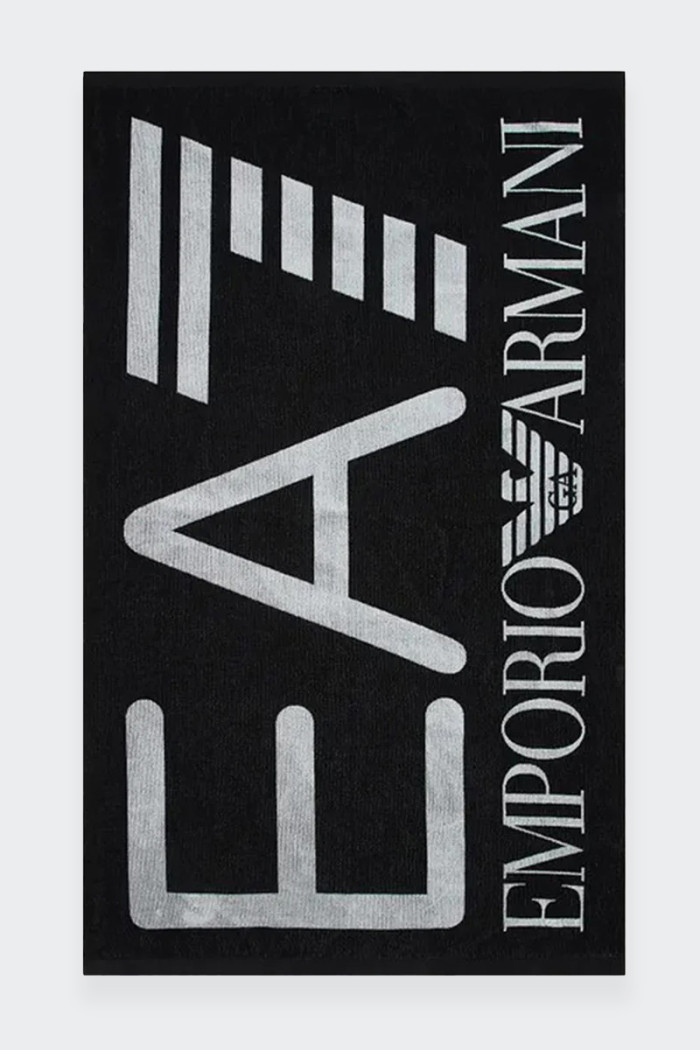 Emporio Armani EA7 unisex beach towel made of 100% cotton. The maxi logo gives it a unique touch of style. The perfect accessory