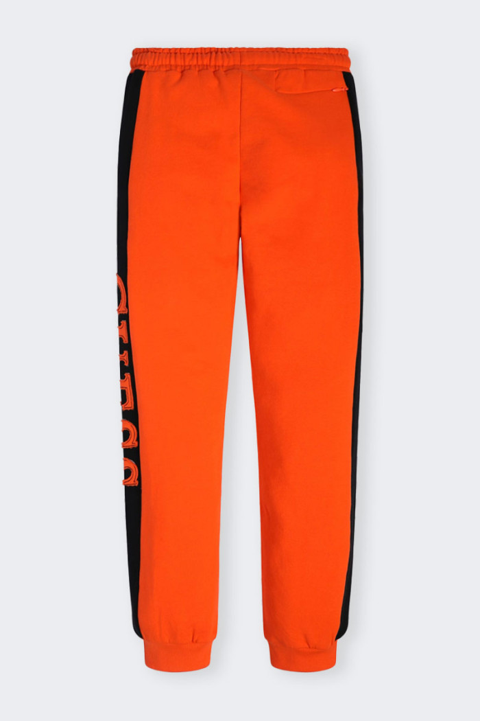 Orange sweatpants for boys and girls made of cotton. Elastic waistband with drawstring and leg with elastic at bottom. Side logo