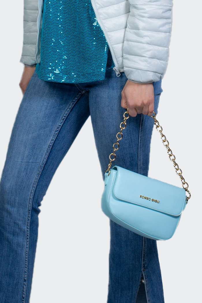 Women's light blue shoulder bag featuring a golden chain and an additional longer strap in a modern and youthful design that wil