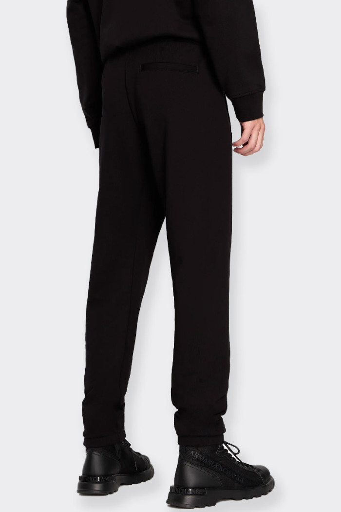 men’s black jogger pants made of French terry cotton with sporty style. Side pockets and a welt on the back side featuring the m
