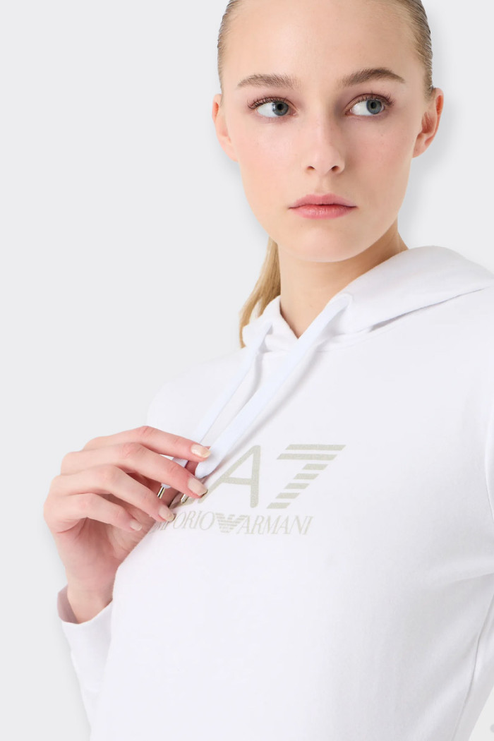 Women’s sweatshirt made of stretch cotton, characterized by regular fit. The model, equipped with a practical hood and a pouch p